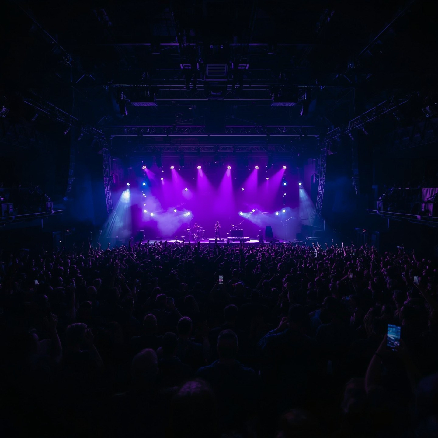 Crowd at a live concert under purple stage lights