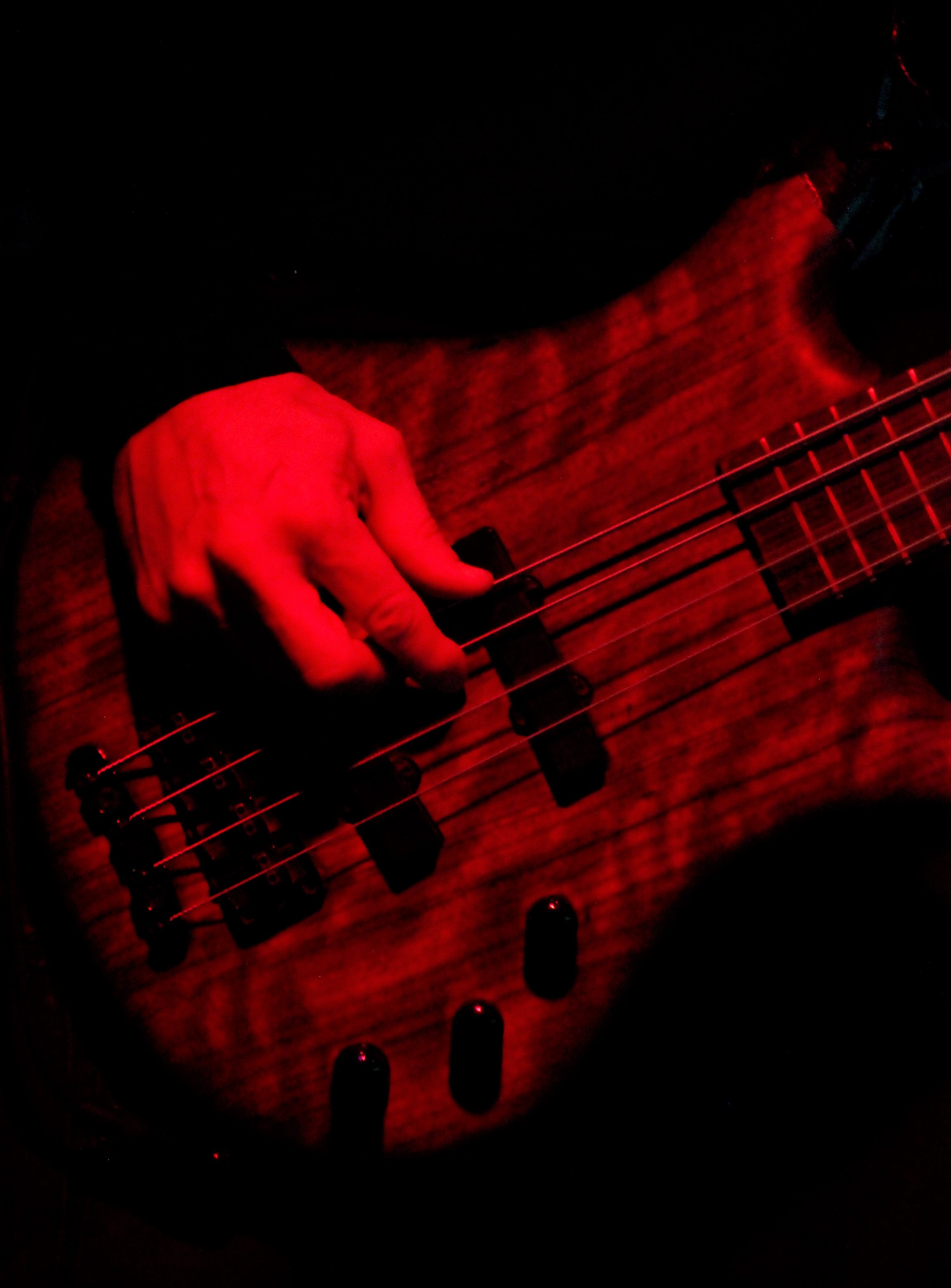 Bass guitar lit in red stage light