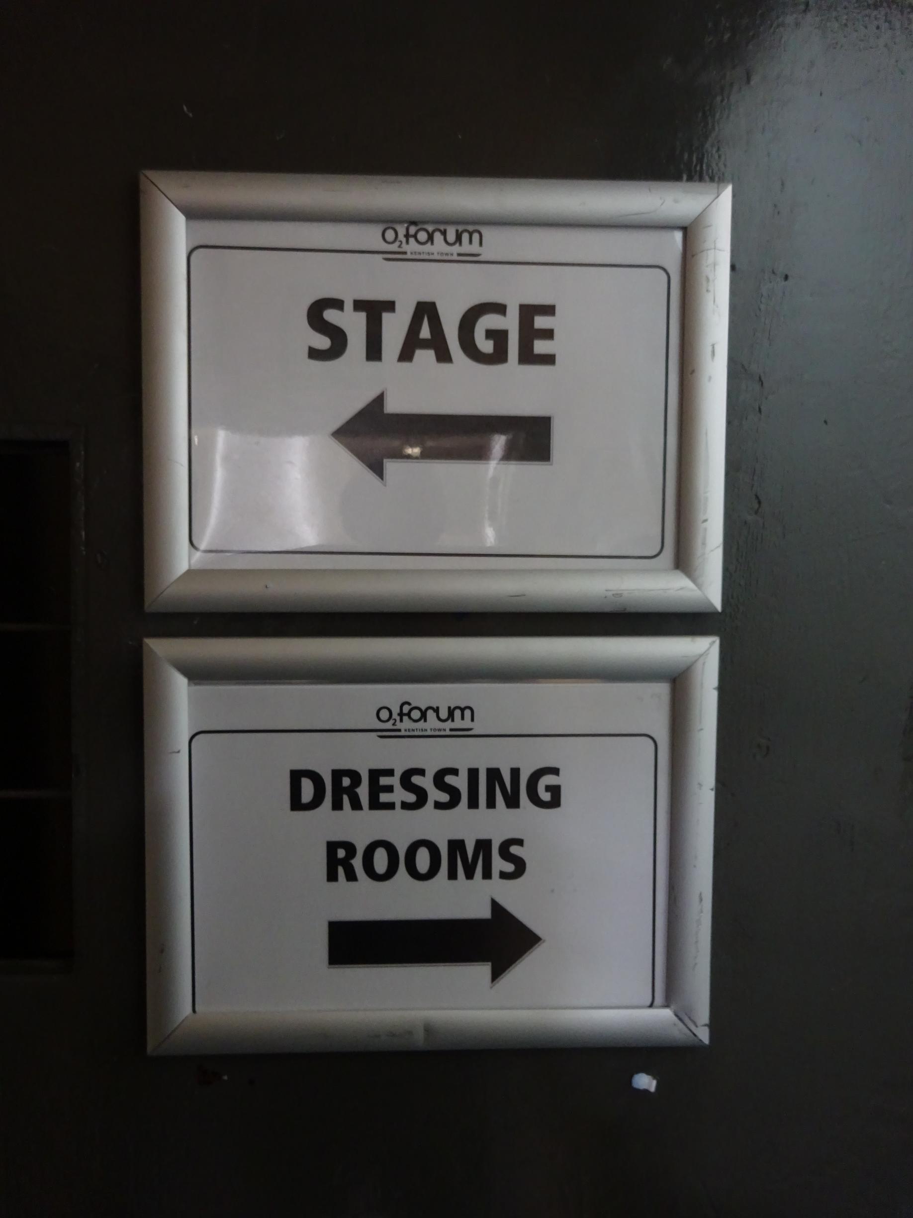 Stage and dressing room signage backstage at a venue