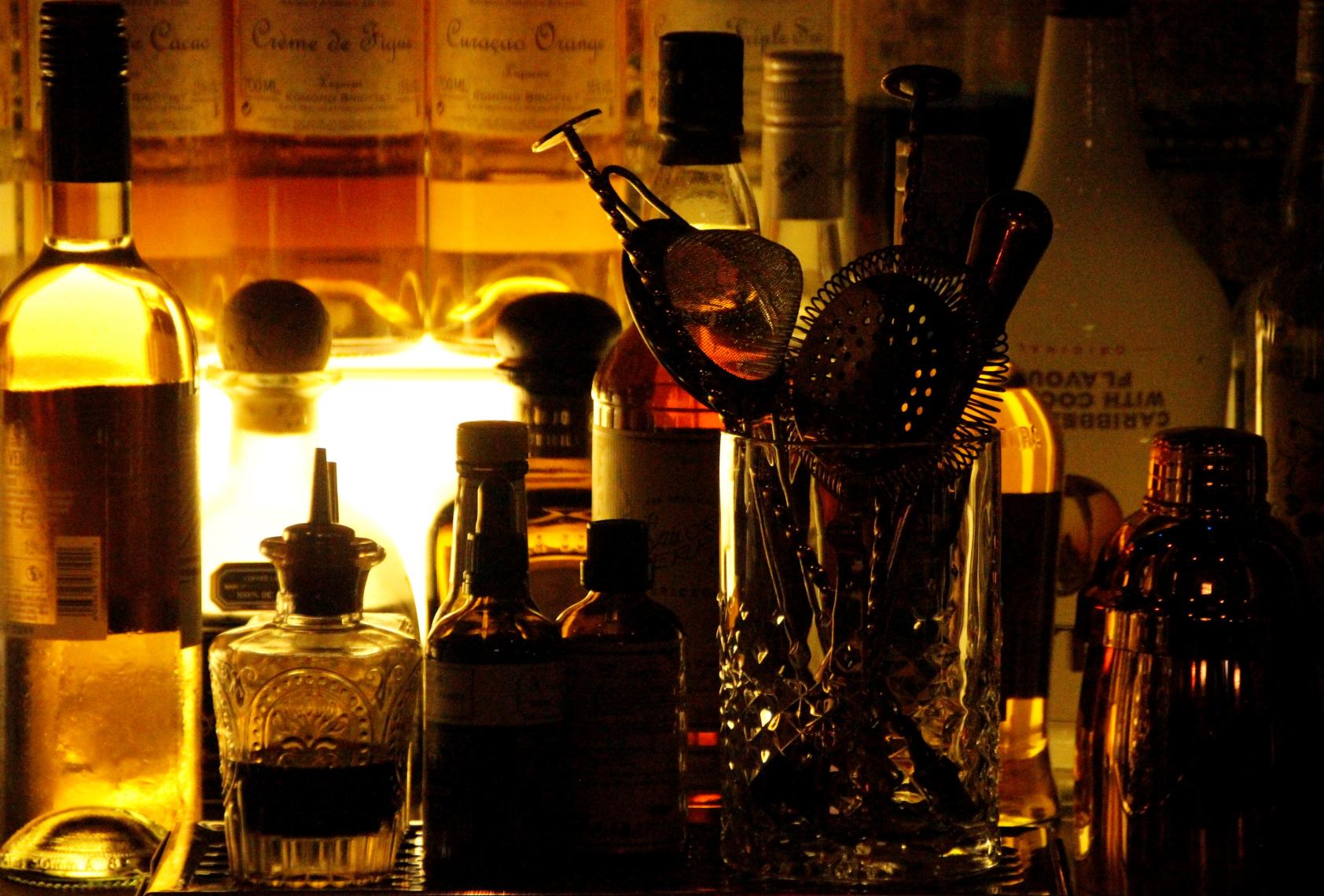 Bottles lit up behind a venue bar